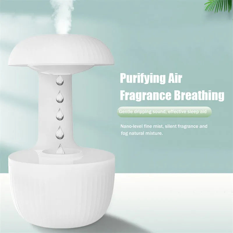 White anti-gravity air humidifier with levitating water drops and USB cable on a desk