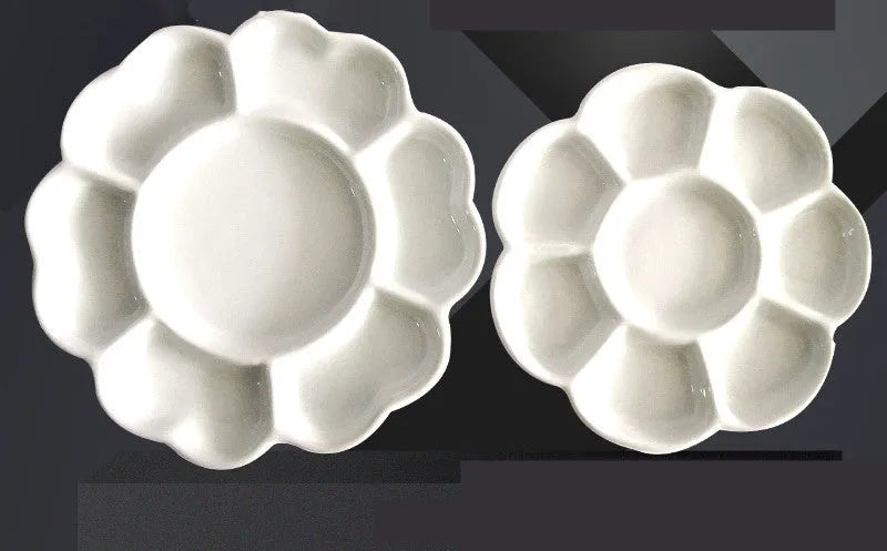 White handmade ceramic plum blossom shaped artist palette for painting.