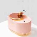 Green rotating planet USB humidifier with night light on wooden surface
