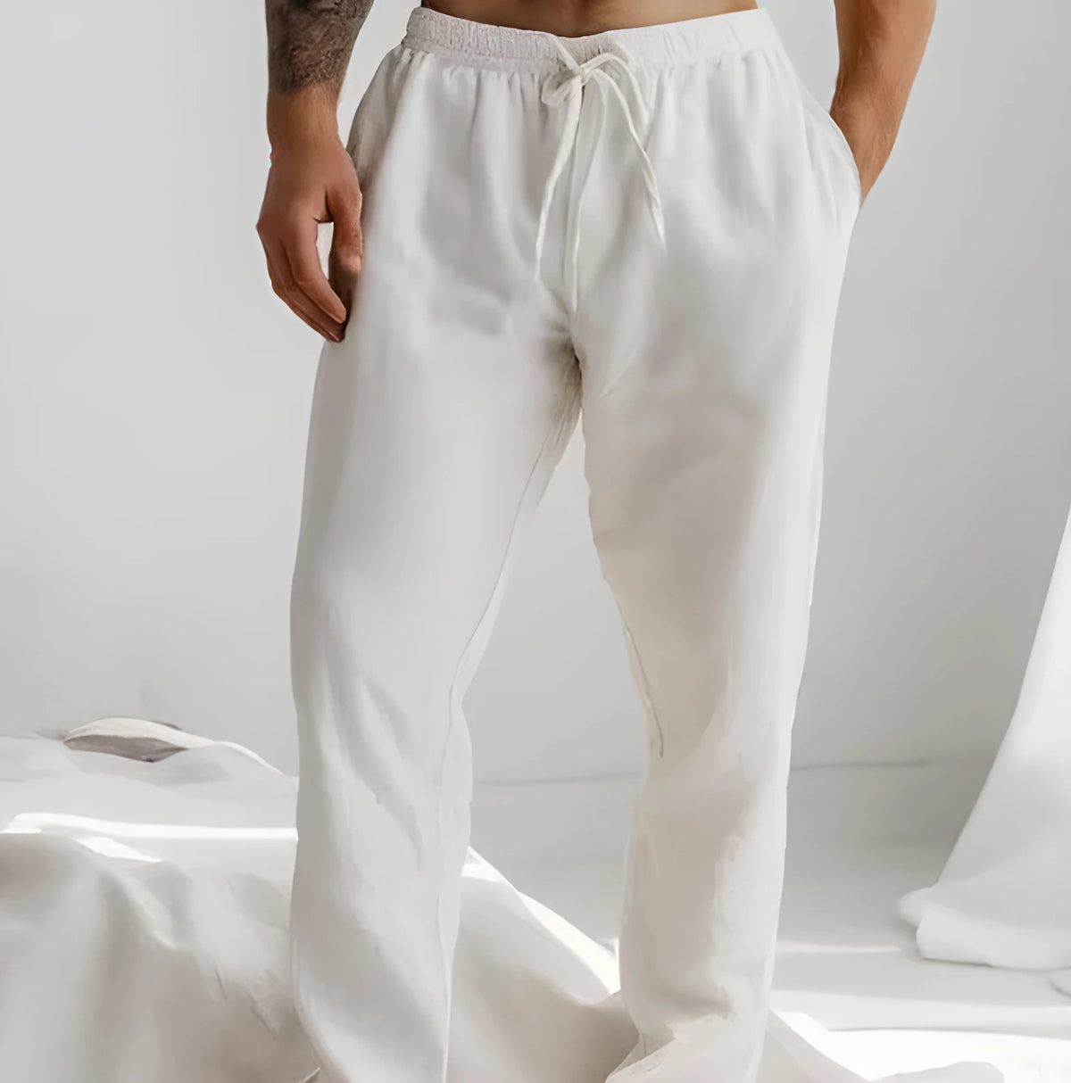 Men's light grey loose-fit summer trousers with a drawstring elastic waist and straight legs.