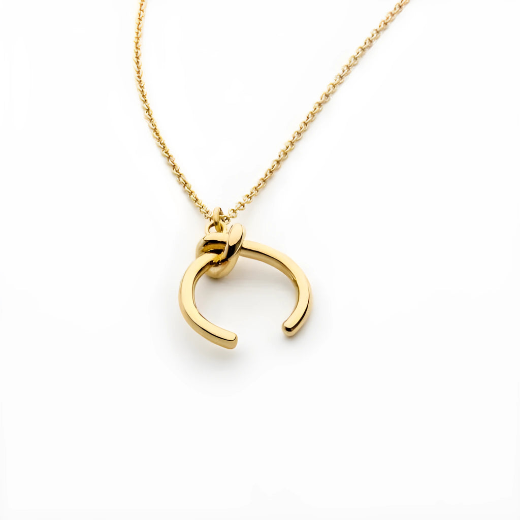 Gold and silver geometric copper pendant necklace on an adjustable cross chain.