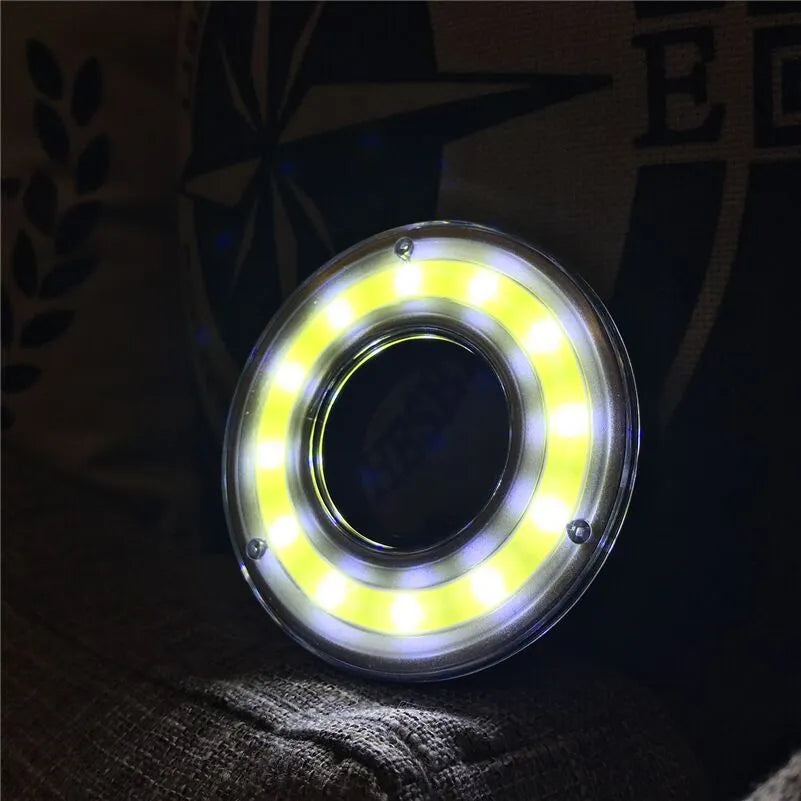 Primary colour COB LED tent light with carabiner hook and transparent lampshade on a dark background