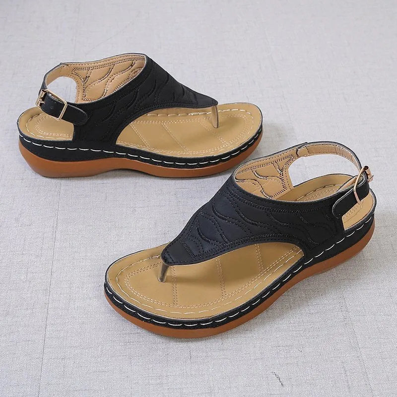 Women's wedge heel sandals with an adjustable buckle strap in a solid colour