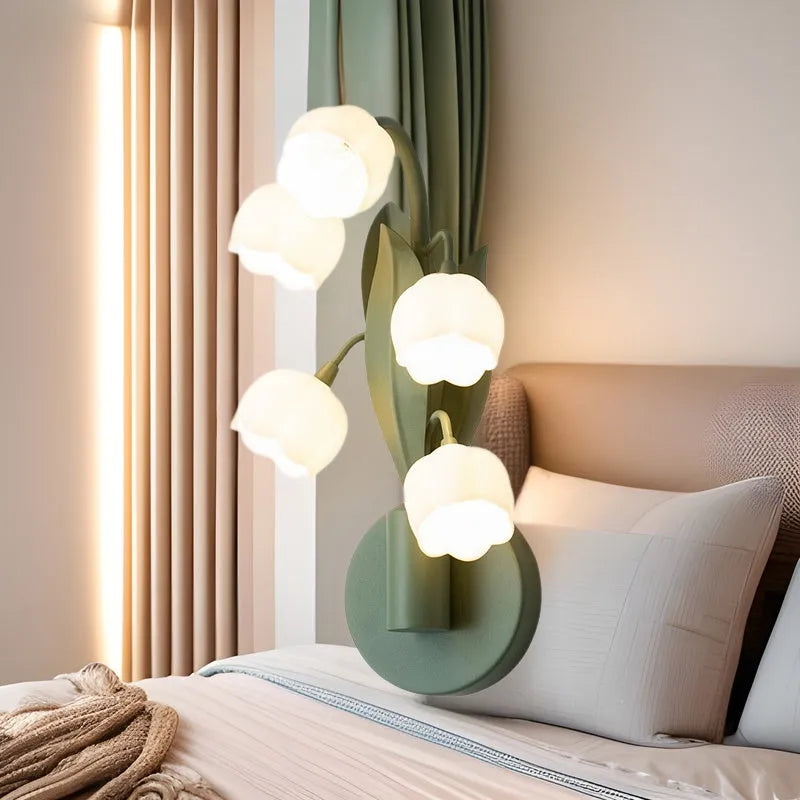 Modern minimalist French pastoral wall lamp with a green tricolour light and white PC shade mounted on a bedroom wall.
