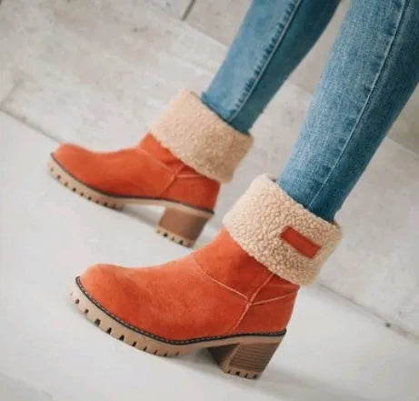 Women's black suede mid-tube snow boots with a thick heel and round toe on a waterproof platform sole.