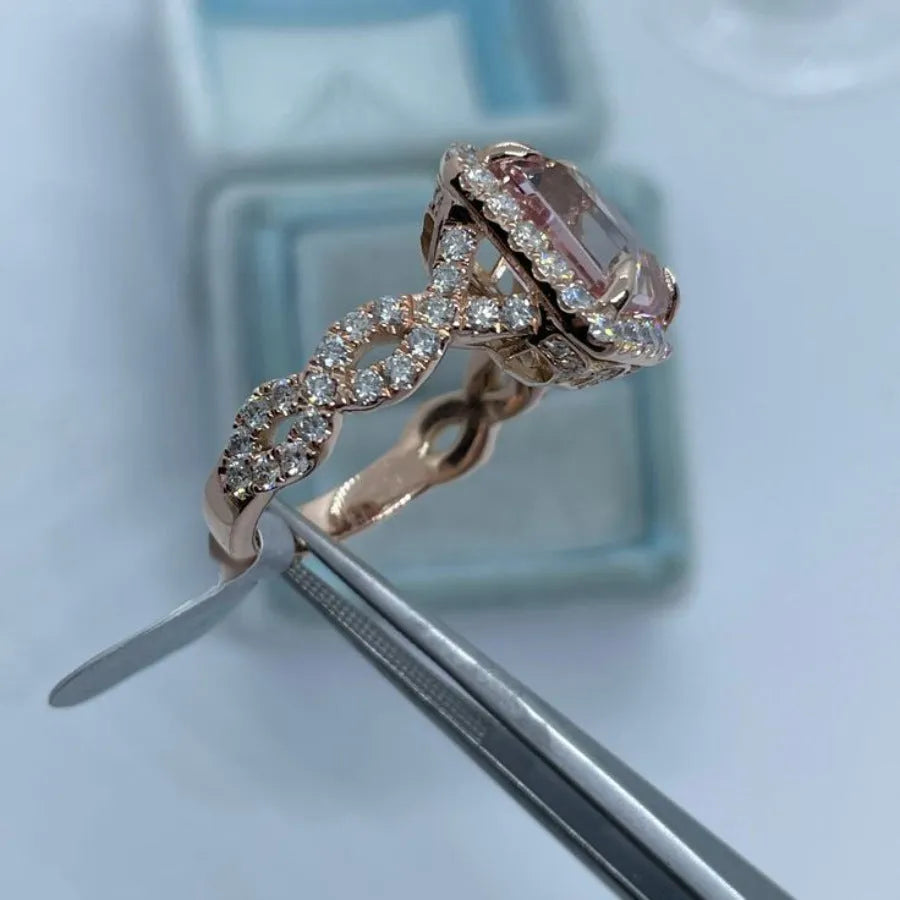 Rose gold geometric alloy ring on a plain background, showing its electroplated finish.