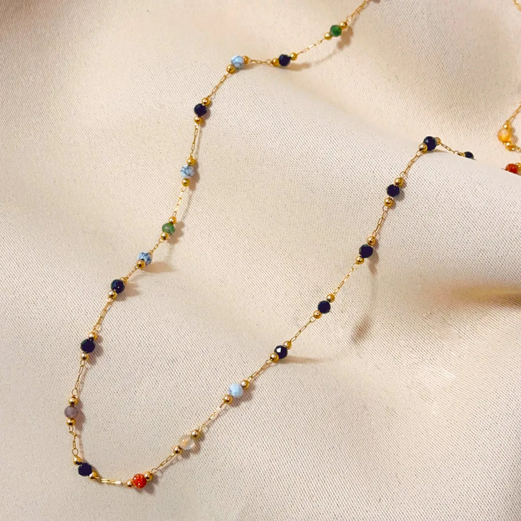 Gold coloured titanium steel necklace with natural stone pendant on O-ring chain.