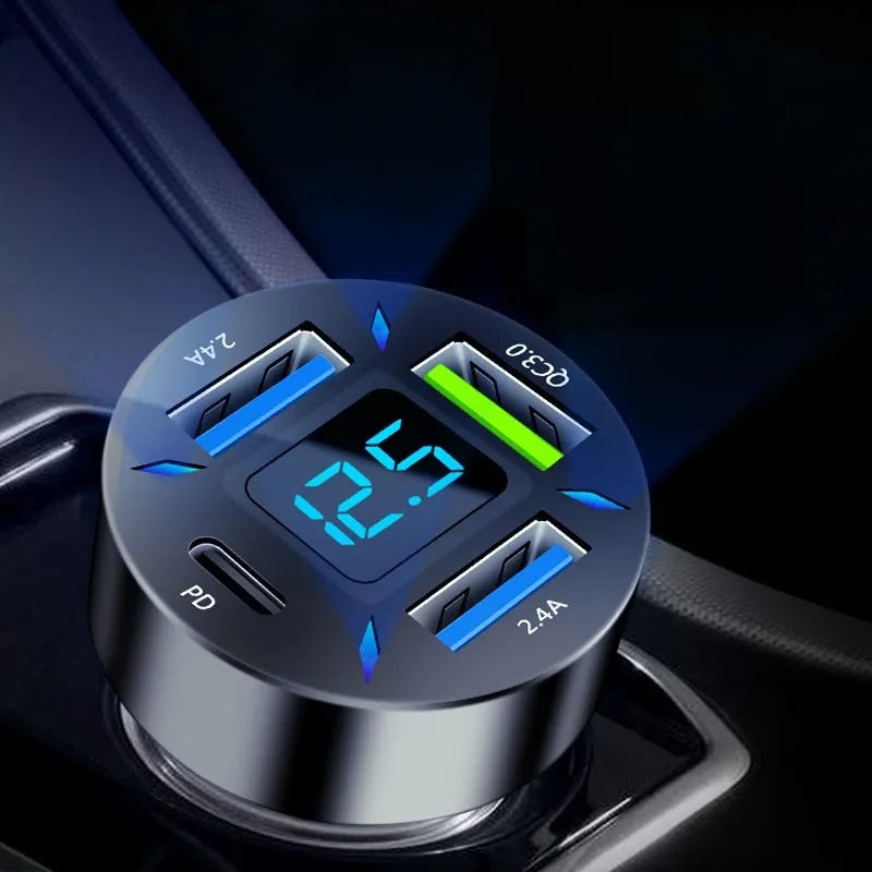 Four-port USB car charger with digital LED display plugged into a car dashboard