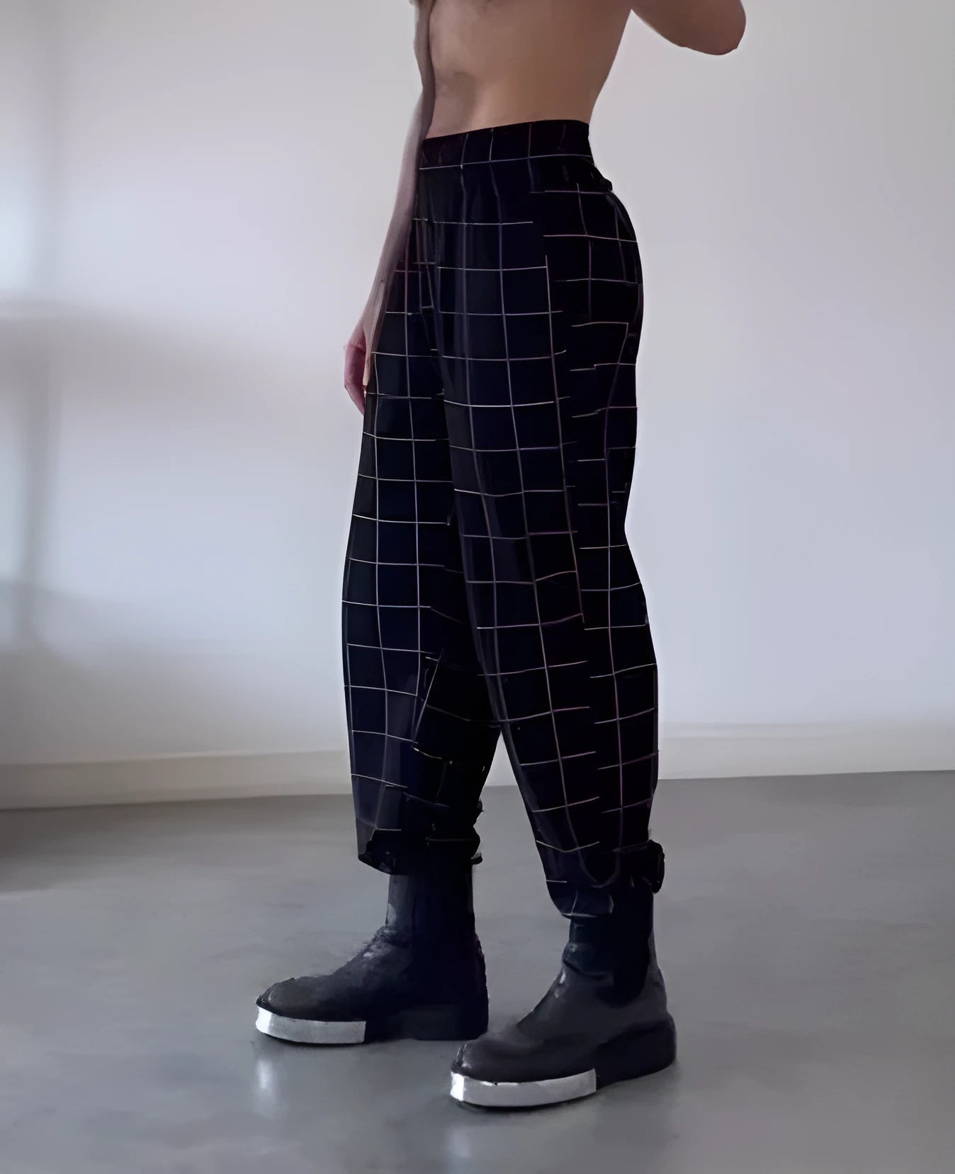 Men's plaid trousers with apron waistband, relaxed fit, and side pockets.