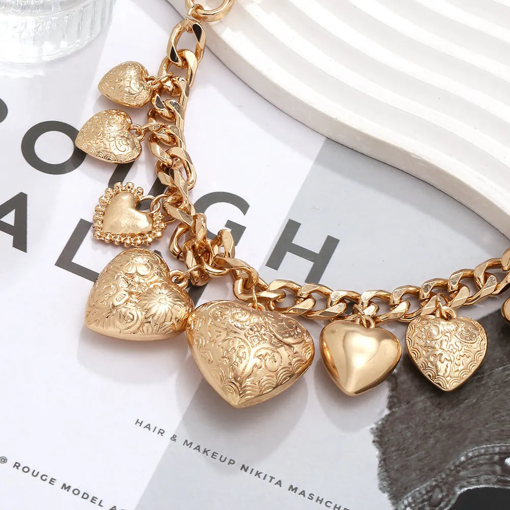 Gold carved heart pendant necklace on adjustable metal chain for women