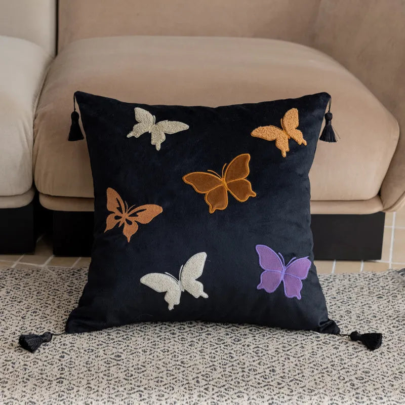 Square beige cushion with detailed purple and black butterfly embroidery in a Chinese floral pattern.