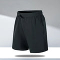 Man wearing loose-fit black quick-dry polyester sports shorts on a beach