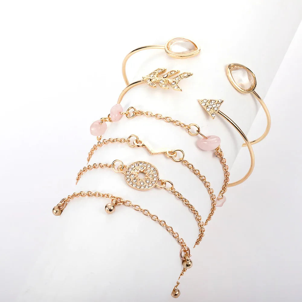 Set of six gold fashion bracelets with water droplet, arrow, V-shape and drill designs.