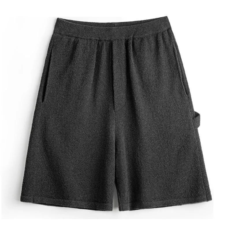 Cement grey straight leg sports shorts with a loose fit and elasticated waistband on a neutral background.