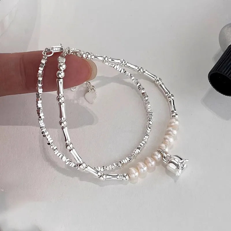 Silver pearl Lily of the Valley pendant bracelet on display