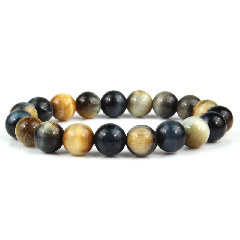 Finished round tiger eye crystal bracelet in multiple colour options on a wrist.