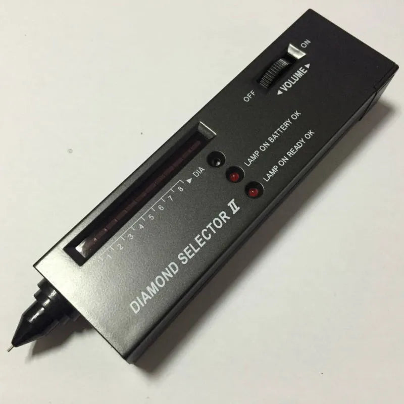 Black handheld Diamond Thermal Conductivity Tester with metal probe on a dark surface.