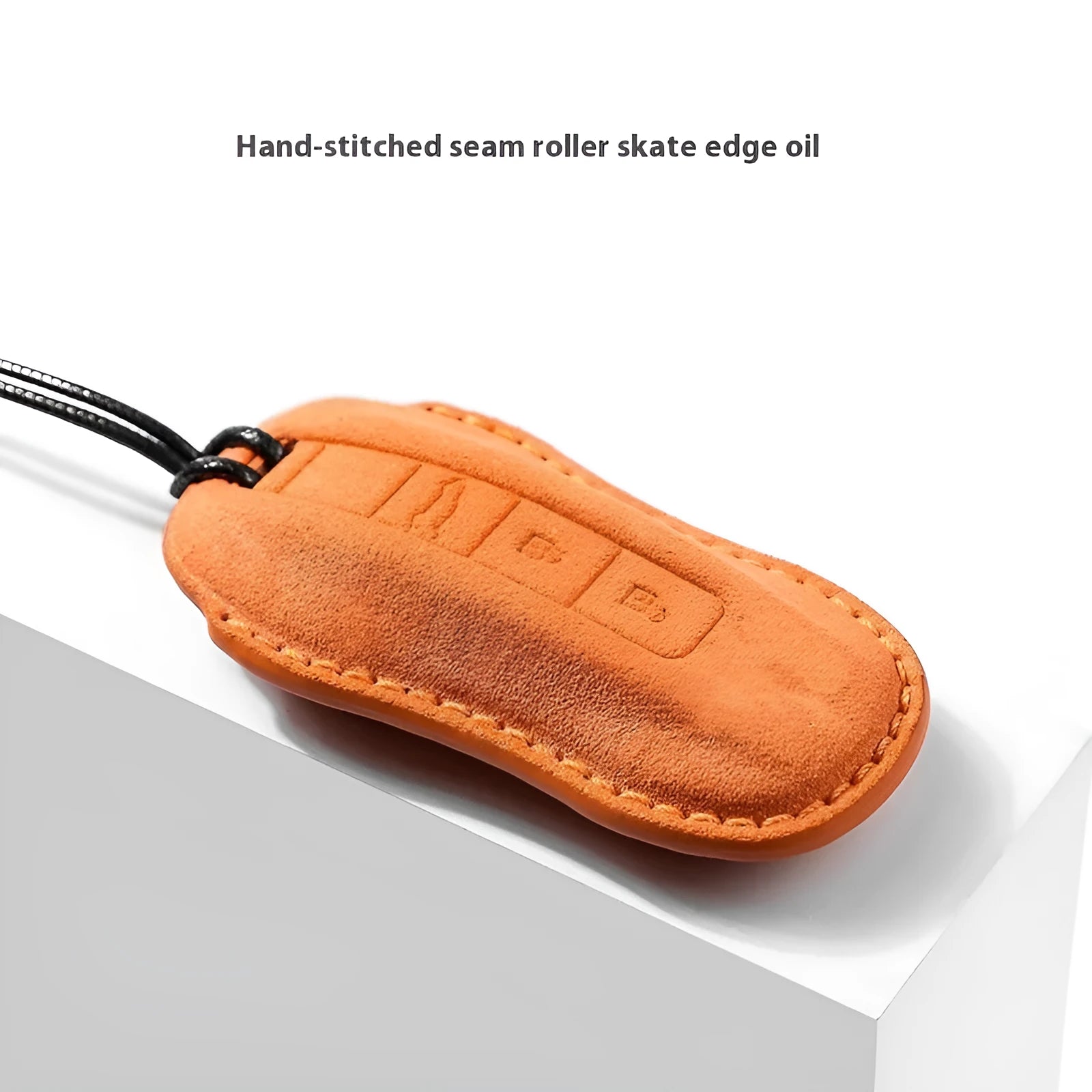 Suede car key cover shown in cement grey, dark green, light grey, and orange colour options.