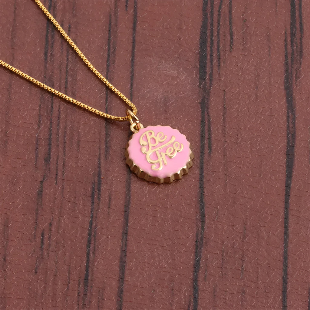 Copper 18K gold plated bottle cap pendant necklace with 40cm box chain on a neutral background