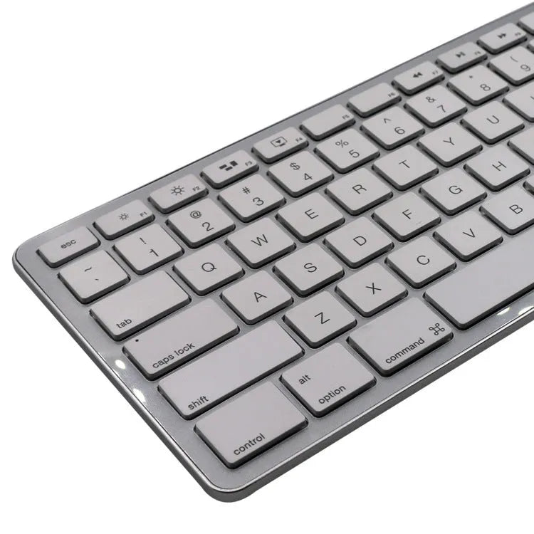 White 109-key wireless Bluetooth keyboard with three-key zone on desk