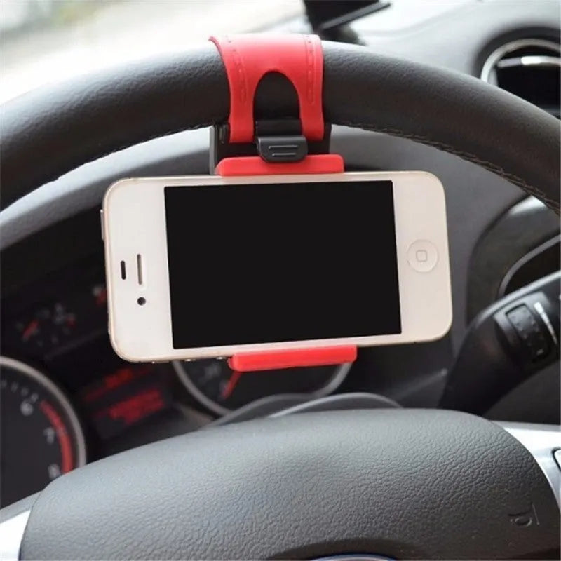 Black steering wheel phone holder clip mounted on car steering wheel holding smartphone