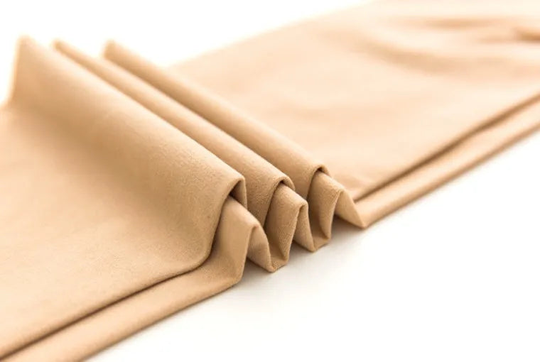 Beige and black stovepipe socks for hip and abdomen lifting, made from polyester fibre.