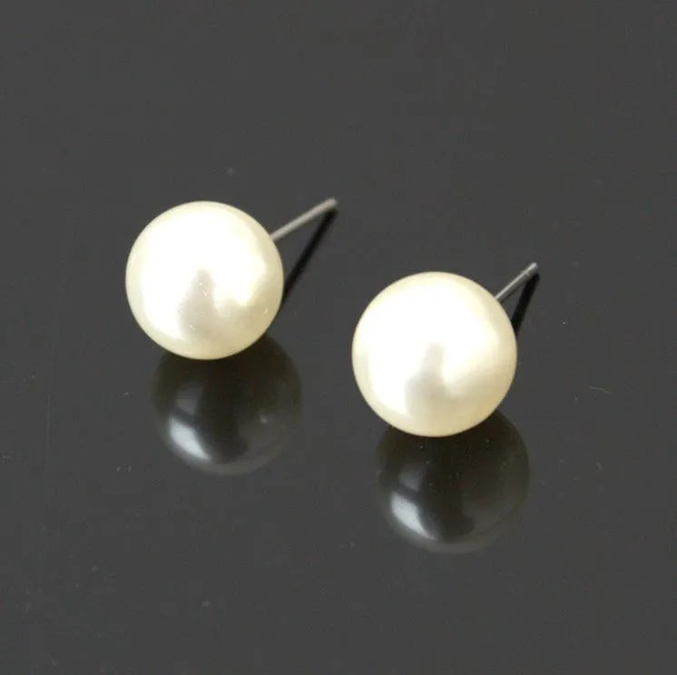 White plastic resin pearl-style jewellery set including necklace, earrings, and bracelet on display