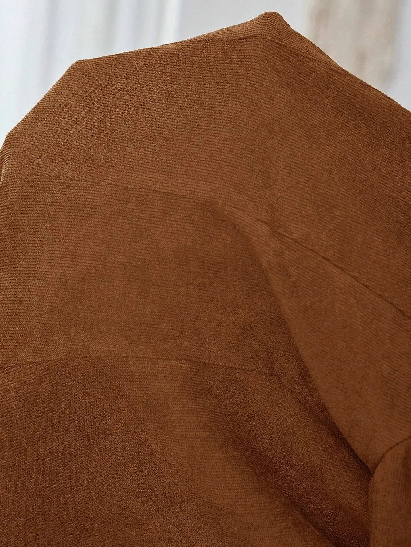 A brown lapel single-breasted long sleeve leisure suit coat.