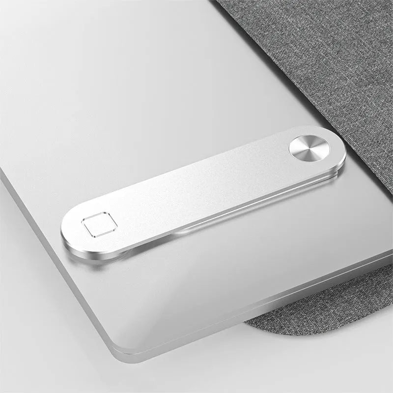 Black aluminium magnetic phone holder mounted on side of laptop screen with smartphone attached.