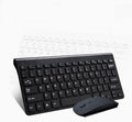 Black and white 2.4 GHz wireless keyboard and mouse set with USB receiver on a desk.