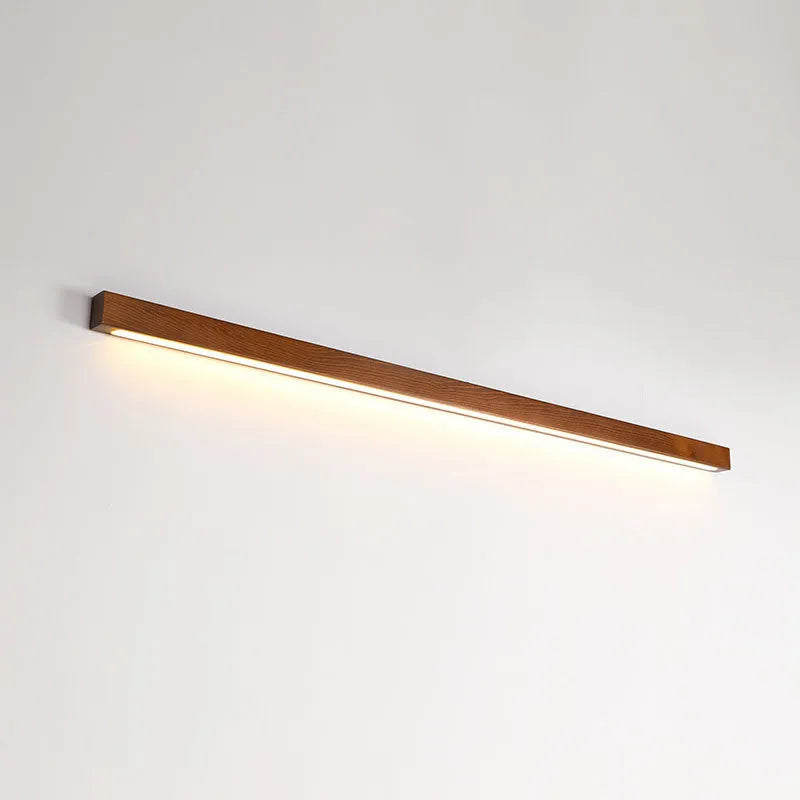 Walnut-coloured long wooden log strip wall lamp with LED lighting in a minimalist design.