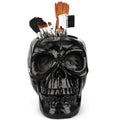 Skull head resin storage tube in black, 11x15x11cm, with brain-shaped interior