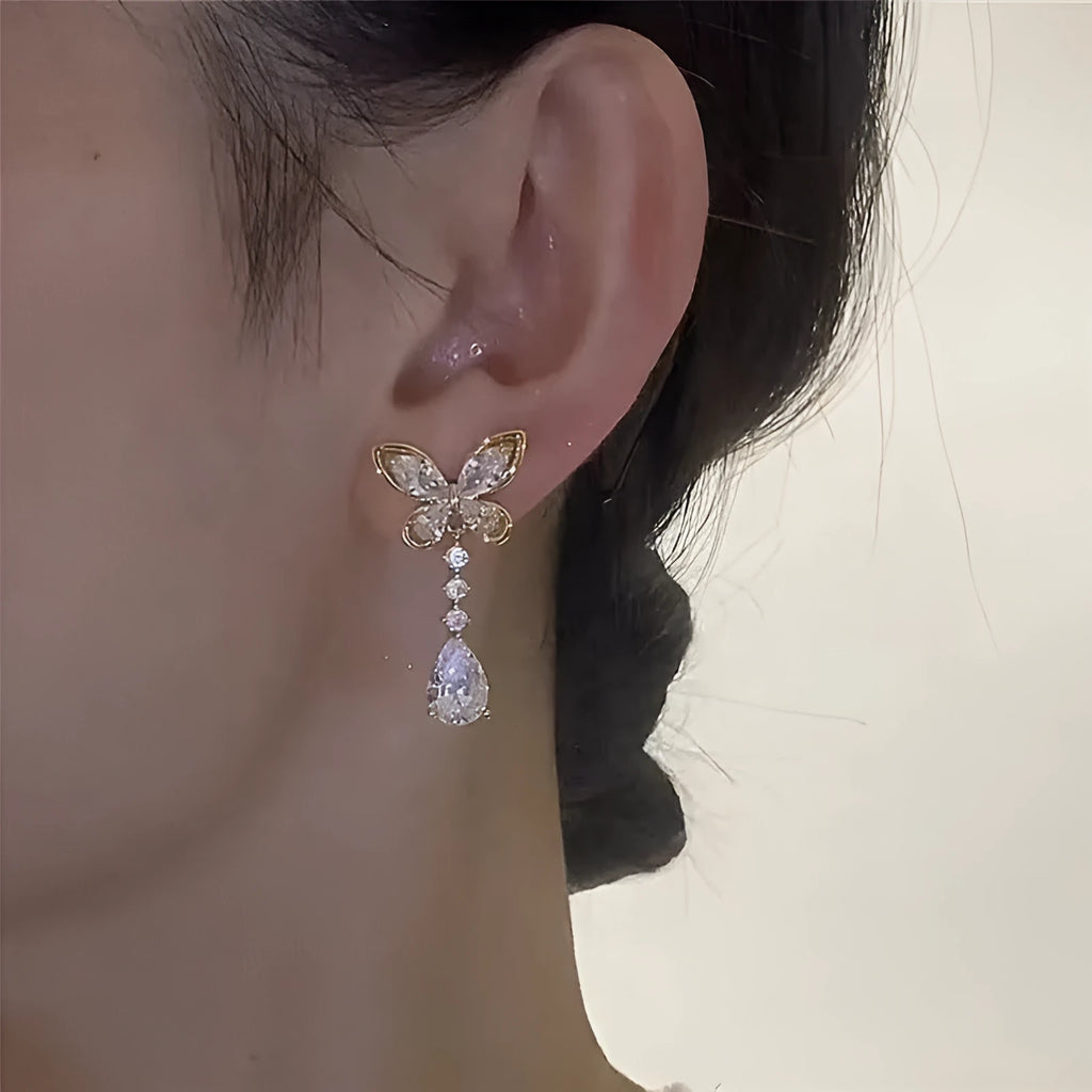 Platinum bow stud earrings with zinc alloy construction and electroplated finish