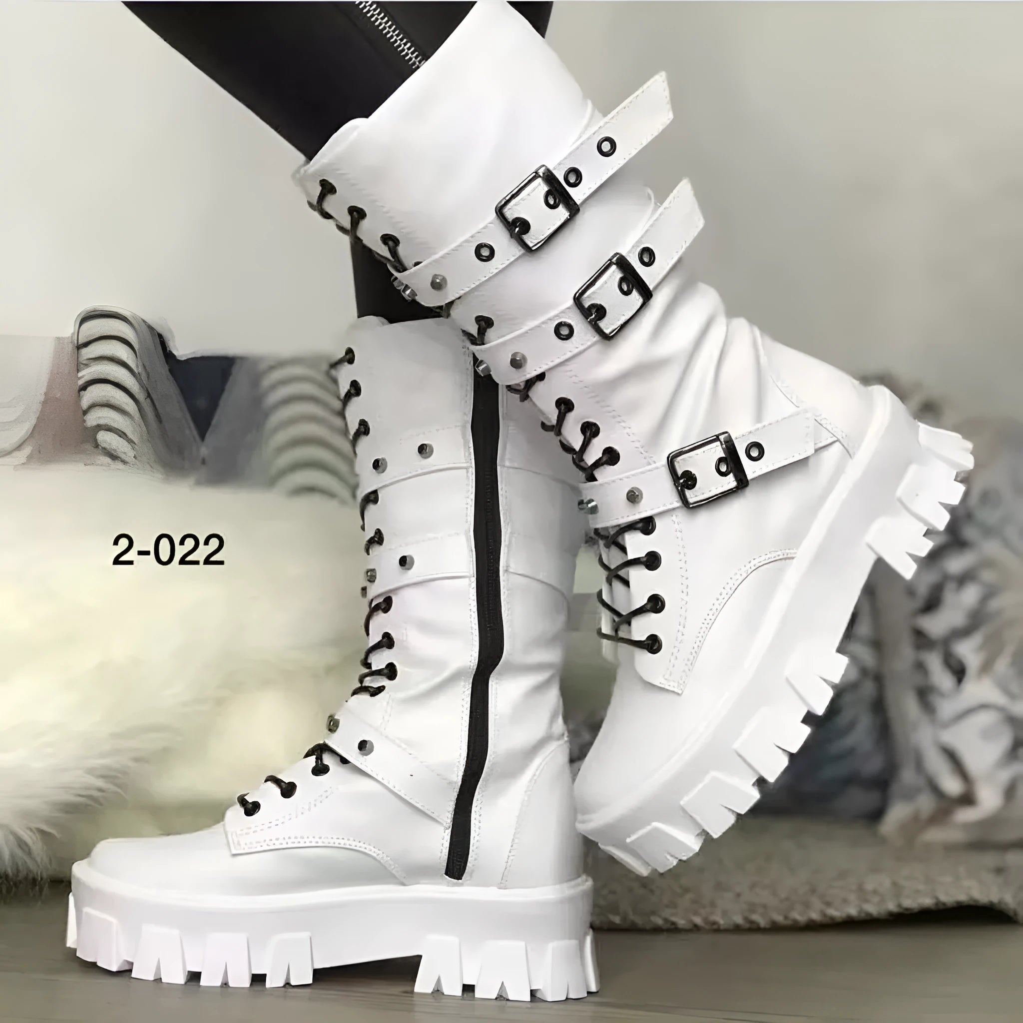 Women's black mid-calf buckle boots with side zipper and round toe, showing metal buckle detail