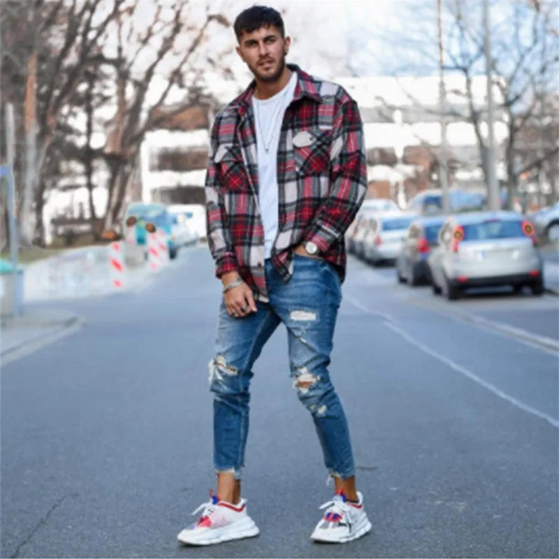 Deep blue men's jeans showing distressed hole details on the legs