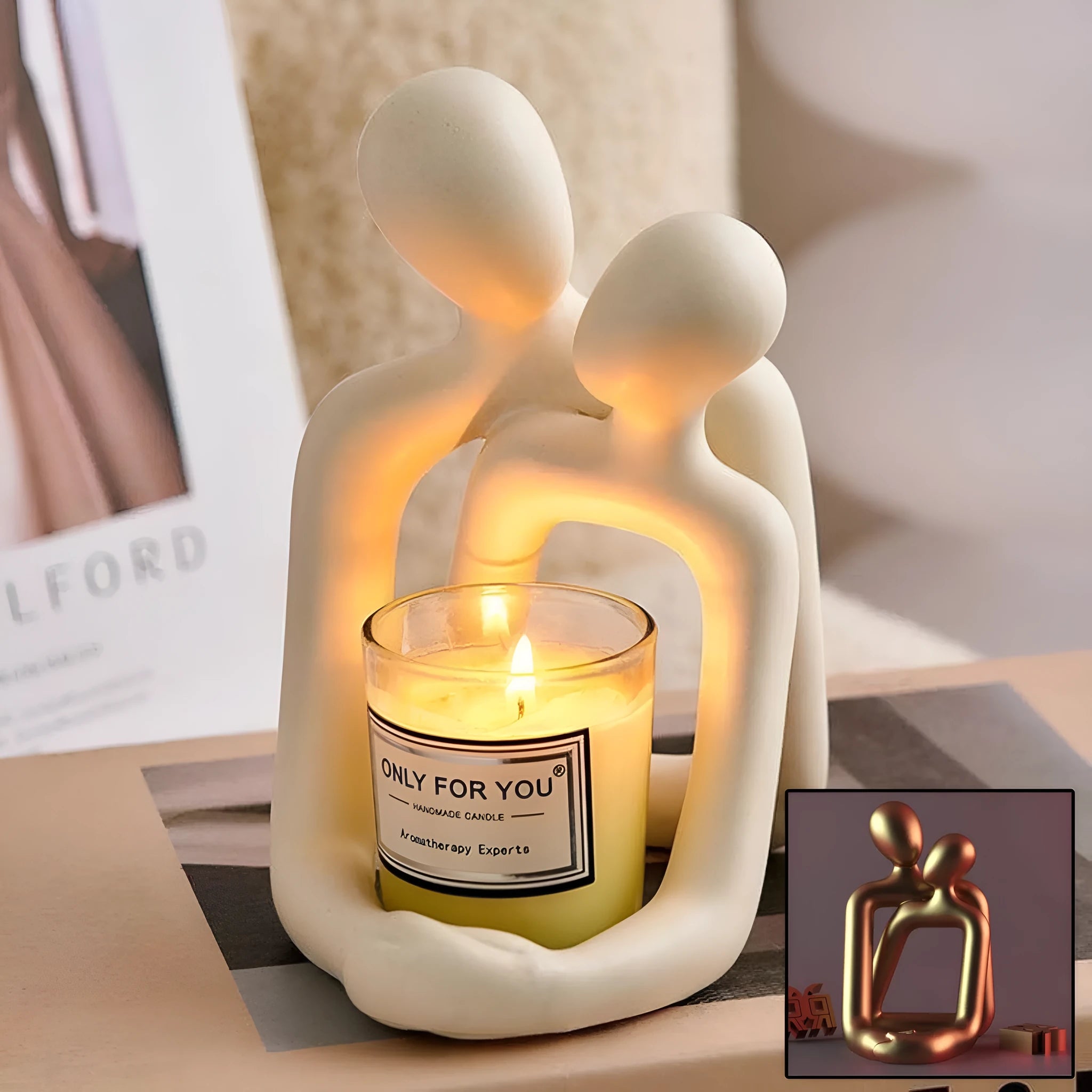 Modern minimalist resin statue of a couple in milky white or gold colour on a wooden surface.