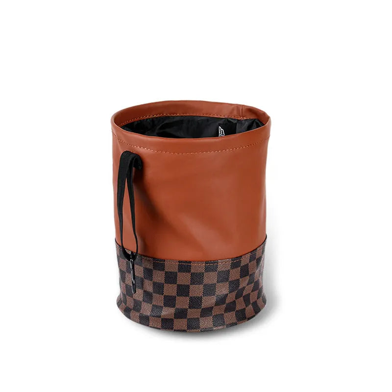 Retractable leather car bin showing folding design with carry handle for vehicle waste management