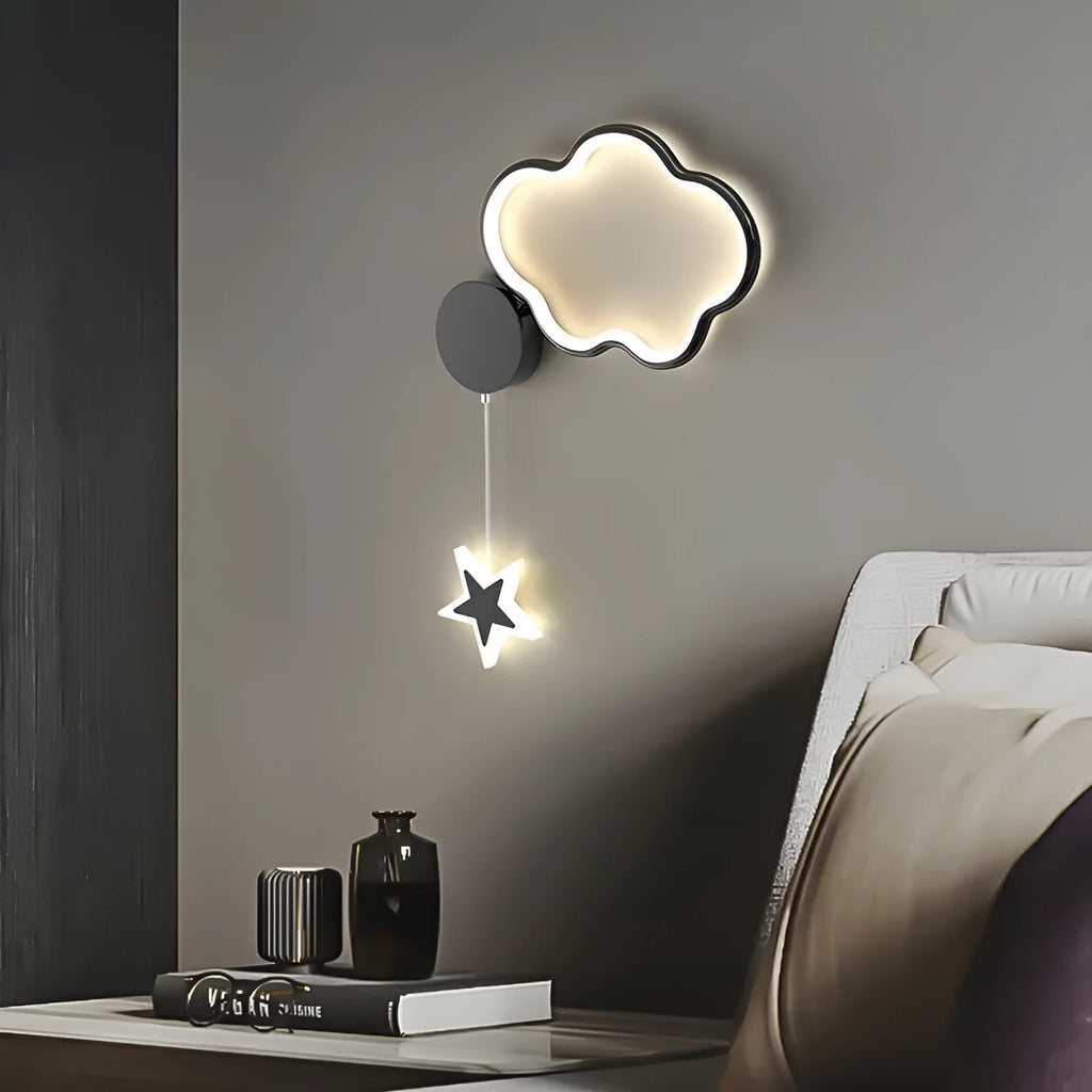 White cloud-shaped children's wall lamp with 3-colour LED light mounted beside a bed.