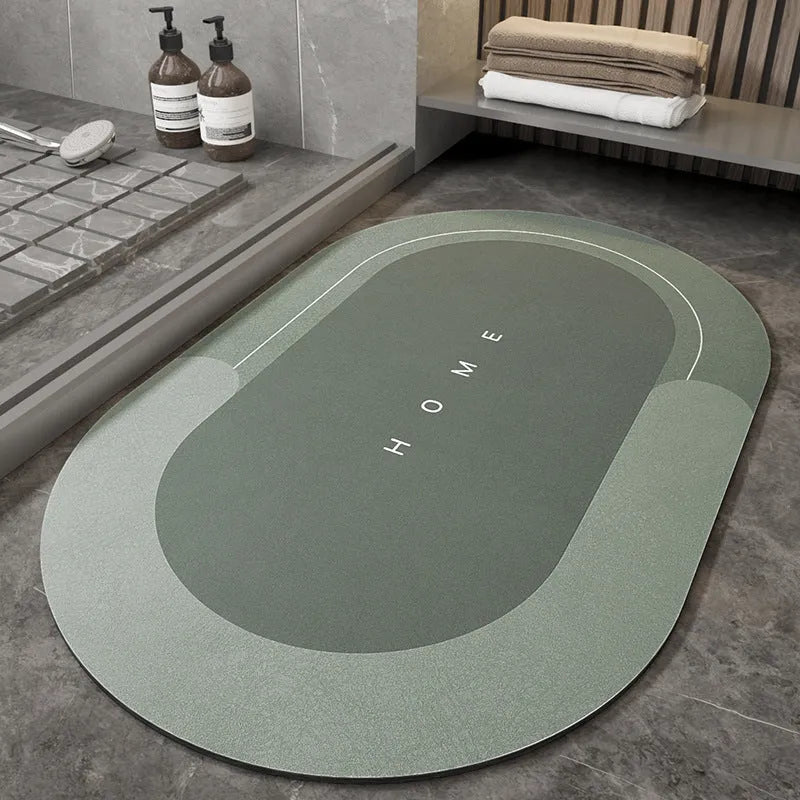 Blue oval blended bathroom floor mat on tiled floor next to a bath.