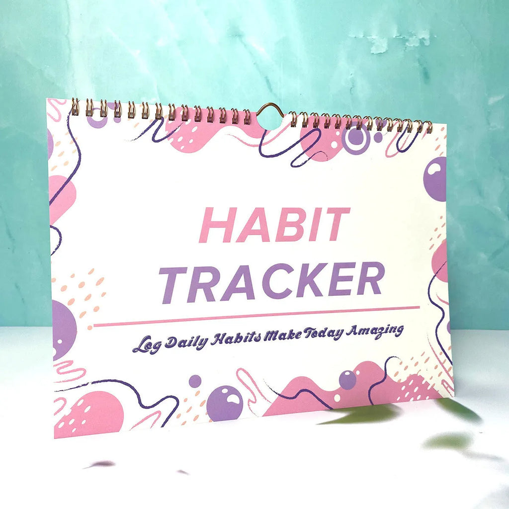 12-page habit tracking journal in pink and white, showing its 21cm by 28cm size.