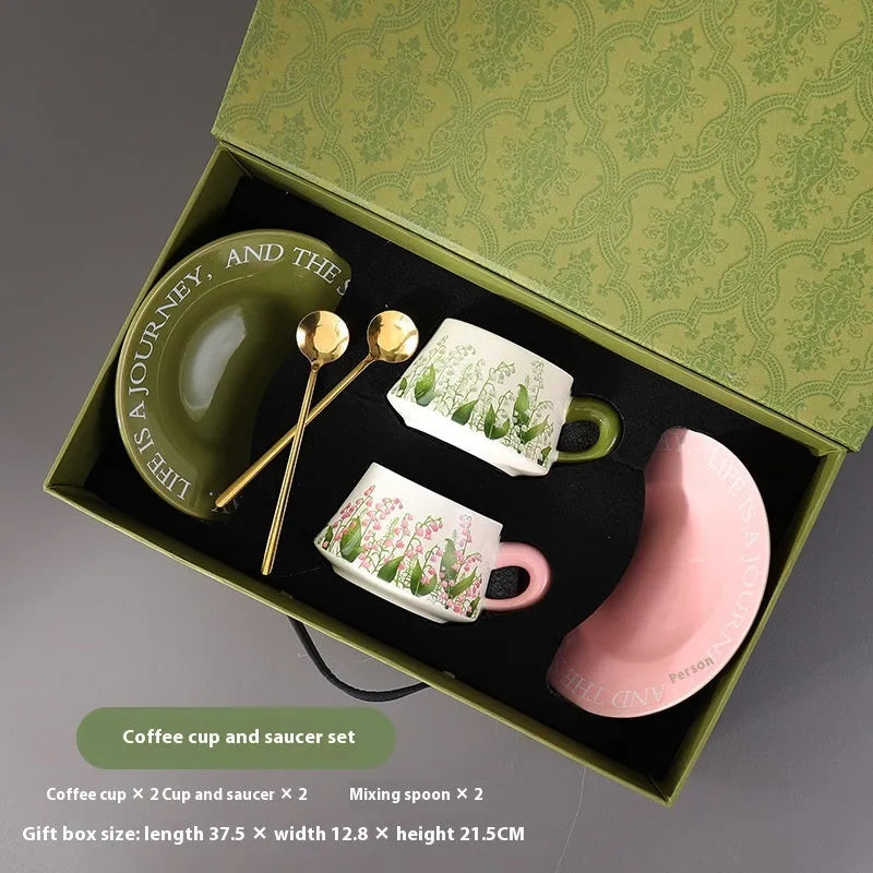 Ceramic coffee cup and saucer set with two cups, two plates, and two spoons in Campanula design