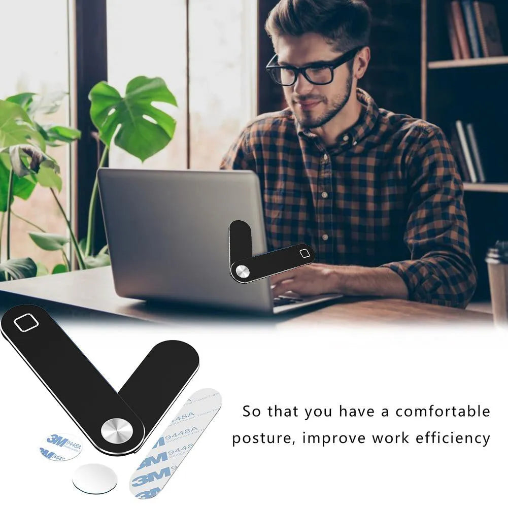 Black aluminium magnetic phone holder mounted on side of laptop screen with smartphone attached.