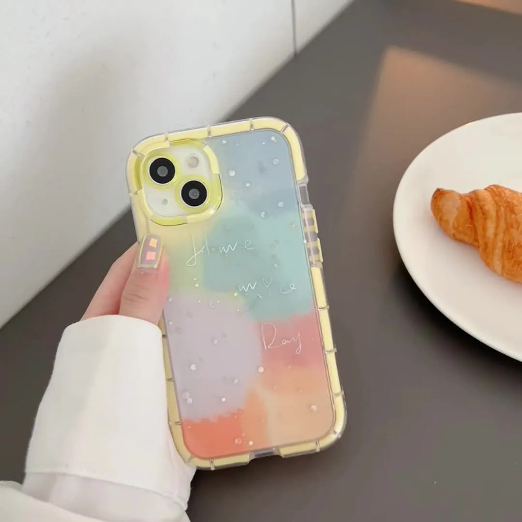 Minimalist iPhone case with a yellow edge on a phone, showing its slim TPU construction.