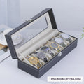 Grey leather watch storage box with see-through lid showing organised watch storage compartments