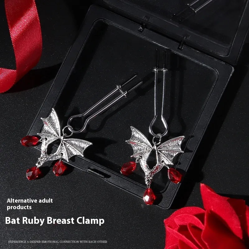 Silver alloy bat nipple clamp with red ruby bat clip decoration.