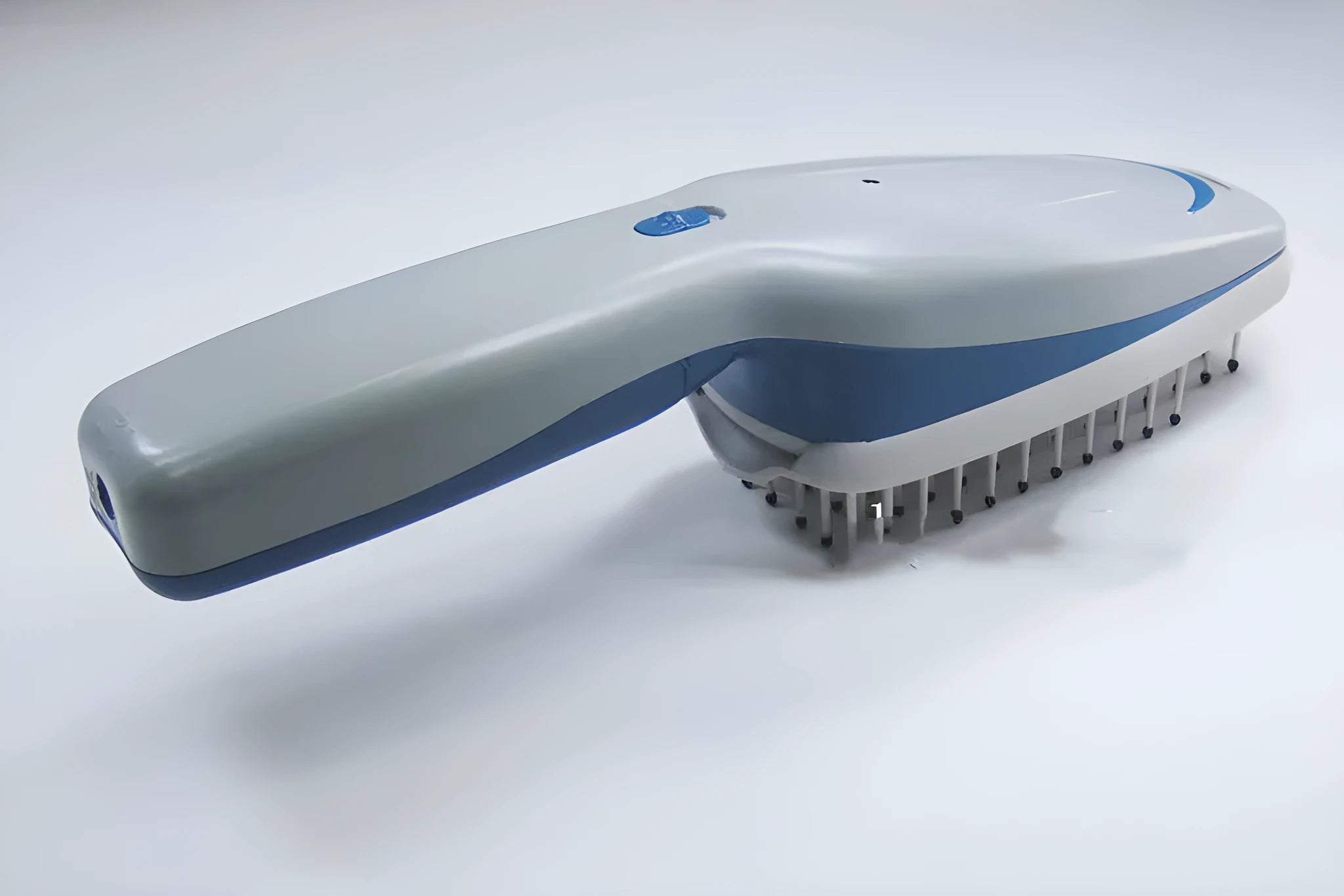 A white pet comb with a removable brush head and a handle housing negative ion and active oxygen technology.