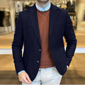 Men's loose fit cotton suit jacket in army green colour, showing tailored retro style on a hanger.