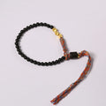 Hand-woven obsidian carrying strap bracelet with textured finish on wrist