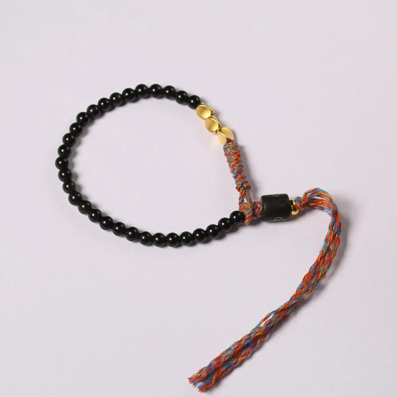 Hand-woven obsidian carrying strap bracelet with textured finish on wrist
