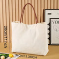 Large beige white canvas tote bag with a reinforced flat base and roomy interior.